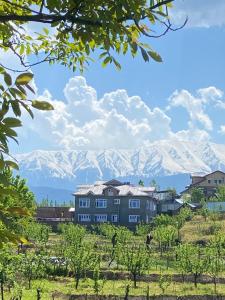 a city with mountains in the background and a building at THE GULMARG PALACE in Gulmarg