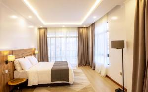 Ένα ή περισσότερα κρεβάτια σε δωμάτιο στο MAYA Residences Rwanda