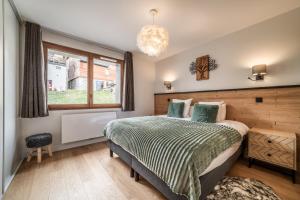 a bedroom with a bed and a window at Apartment Epicea Alpe d'Huez - by EMERALD STAY in L'Alpe-d'Huez