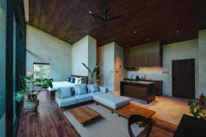 a living room with a couch and a kitchen at Piece Lio Resort from Japan in El Nido