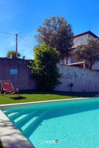 a swimming pool in the yard of a house at Refugio dos Cartolas By ALPONTE in São Mamede