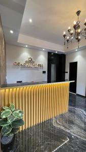 a lobby with a yellow partition and a table at Hotel Golden Suites - Near Nesco in Mumbai