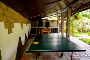 a ping pong table in the middle of a patio at Pensiunea Namaesti - Inchiriere integrala in Nămăeşti