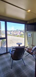 a room with a table and chairs and a large window at Doolin Inn in Doolin