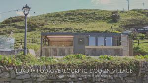 a rendering of a building with a hill in the background at Doolin Inn in Doolin