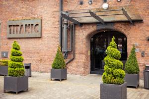 a group of trees in front of a building at Titanic Hotel Liverpool in Liverpool
