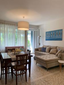 a living room with a couch and a table at Appartamento Jesolo Piazza Drago in Lido di Jesolo