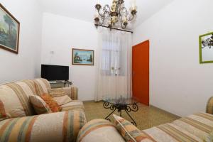 a living room with two couches and a glass table at La Casa Dei Nonni in Agerola