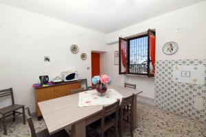 a kitchen and dining room with a table and chairs at La Casa Dei Nonni in Agerola