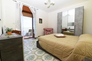 a bedroom with a bed and a table and a chair at La Casa Dei Nonni in Agerola