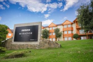 a large sign in front of a building at Mirador del Lago Hotel in El Calafate