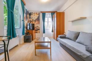 a living room with a couch and a table at Bed and Breakfast Palac in Baška Voda