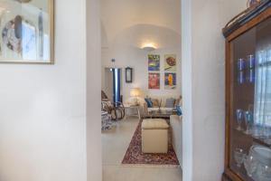 a hallway with a living room with a couch and a table at Tenuta Miro in Ostuni