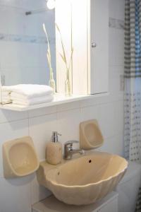 a bathroom with a sink and a mirror at Casa Hara2 in Lefkada Town +7 photos