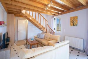 a living room with a couch and a staircase at Casa Hara2 in Lefkada Town
