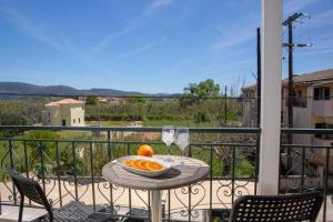 a table with a bowl of oranges on a balcony at Casa Hara2 in Lefkada Town