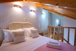 a bedroom with a large bed with white pillows at Casa Hara2 in Lefkada Town