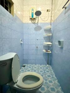 a blue bathroom with a toilet and a shower at Baguio mountain villa view LW in Baguio