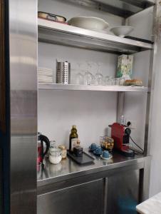 une cuisine avec une étagère et de la vaisselle dans l'établissement Nuovo appartamento in borgo medievale, à Grosseto