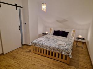 a bedroom with a large bed with two night stands at Całkiem Klawa Enklawa in Brzozie