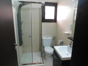 a bathroom with a shower and a toilet and a sink at Paramount Gardens Resorts C201 in Larnaca +34 photos