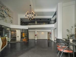 a large lobby with chairs and a chandelier at Zhangjiajie Yeah Hostel in Zhangjiajie