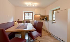 a kitchen and dining room with a table and chairs at Ferienwohnungen Tiroler Haus in Mayrhofen +11 photos