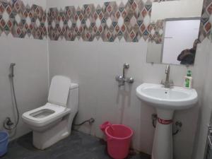 Goroomgo Hotel Happy Home Stay Khajuraho في خاجوراهو: حمام مع مرحاض ومغسلة