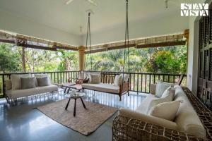 Seating area sa Magnolia Villa by StayVista - A tranquil retreat in greenery with Pool, mountain view, terrace, lush lawn