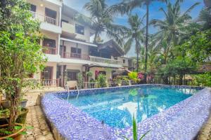 an image of a swimming pool in front of a building at GOA Down D Vilage Prime in Candolim