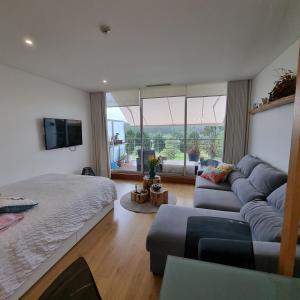 a living room with a bed and a couch at Quinta da Barca Resort in Gandra