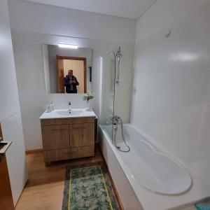 a man taking a picture of a bathroom at Quinta da Barca Resort in Gandra