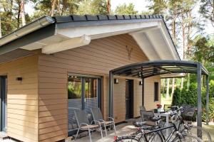 awning over a house with a table and bikes on a patio at Müritzblick in Vipperow