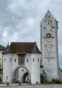un gran edificio blanco con una torre de reloj en Ferienwohnung am Obertor en Pfullendorf