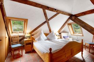 a bedroom with a bed and two windows at Altes Zollhüsli in Schluchsee