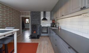 a kitchen with white cabinets and a stove top oven at Mysigt boende I Rättvik med utsikt över Siljan in Rättvik