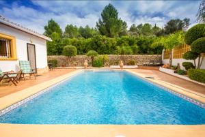 a swimming pool in the backyard of a house at Villa El Huerto in Orba