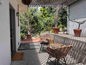 two chairs and a table on a patio at 30 PCT OFF!! Limited Time! Malibu Ocean Wave with King Bed, Walking to Beach and Hiking in Malibu