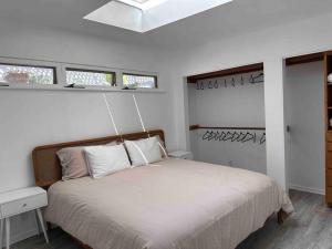 a bedroom with a bed and two windows at 30 PCT OFF!! Limited Time! Malibu Ocean Wave with King Bed, Walking to Beach and Hiking in Malibu