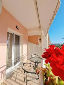 a balcony with a table and chairs on a balcony at Studios Despina in Limenaria