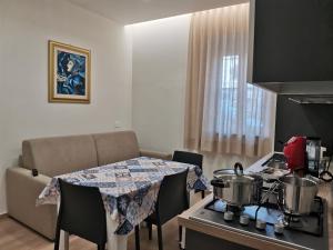 een keuken met een tafel en 2 potten op een fornuis bij Palazzo Buscema - Casa & Vacanza in Crotone