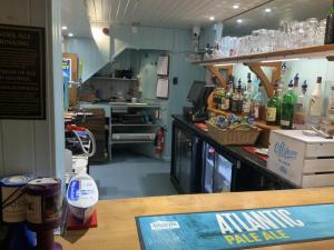 a restaurant with a bar with bottles of alcohol at Wayfarer Inn in Instow