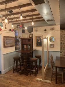 a kitchen with a table and some chairs at Wayfarer Inn in Instow