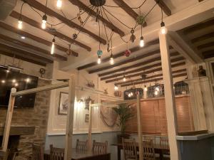a restaurant with a table and chairs and lights at Wayfarer Inn in Instow