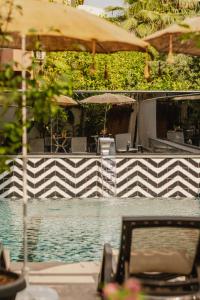 a view of a pool with a table and an umbrella at Ella Suites Hotel in Antalya