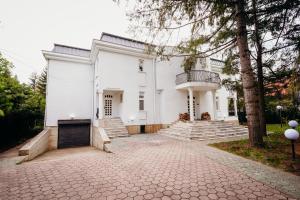 a white house with stairs and a balcony at Knyazheska Banya in Sofia