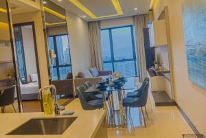 a kitchen and living room with a table and a couch at Crystal Suite at Dorsett Bukit Bintang KL in Kuala Lumpur