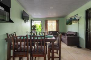 a dining room and living room with a table and chairs at Vacation Home Bartenderluisch in Fortuna