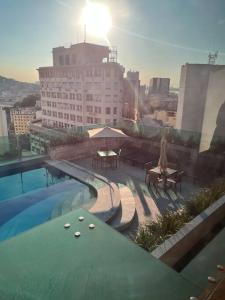 a swimming pool on the roof of a building at Studio Centro Rj- Casa Mauá 1008 in Rio de Janeiro
