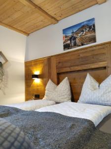 two beds in a room with wooden ceilings at Maurerhof Itter in Itter